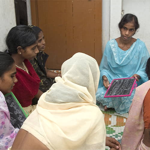 GFA World woman missionary teaches an adult literacy class