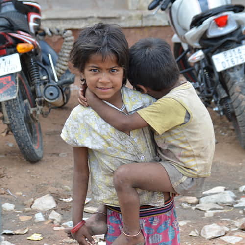 Children in poverty, a girl and her sibling