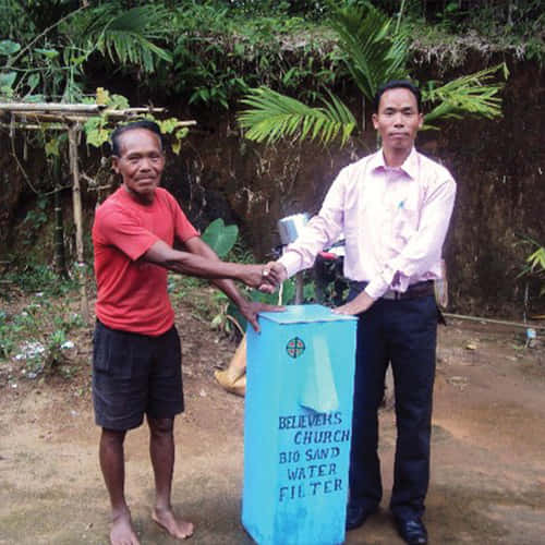 Man receives a water filter from GFA World gift distribution