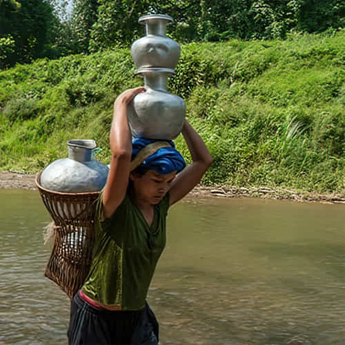 Many women walk long distances to acquire water which is often contaminated
