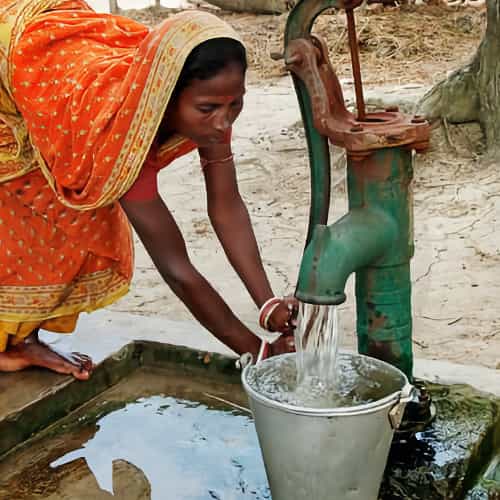 Woman collects clean water through GFA World Jesus Wells