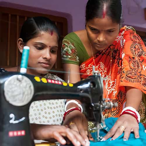 Woman learns how to use a sewing machine through GFA World tailoring class