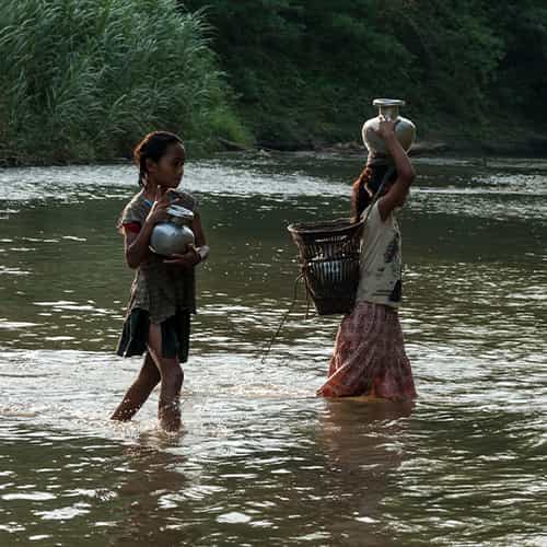 In Asia, women and girls walk long distances to collect water