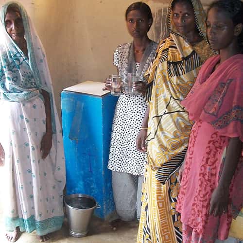 A family enjoys clean water through GFA World Biosand Water Filters