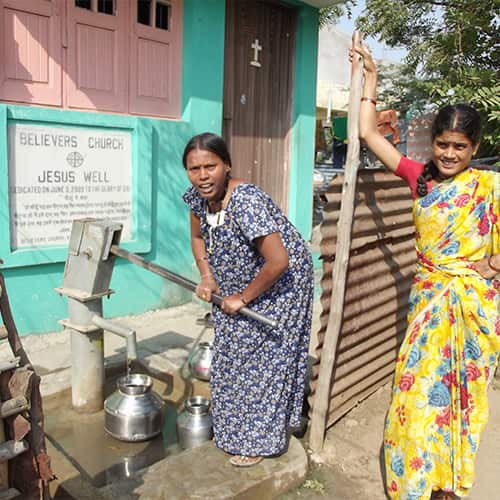 Women drawing clean water through GFA World Jesus Well