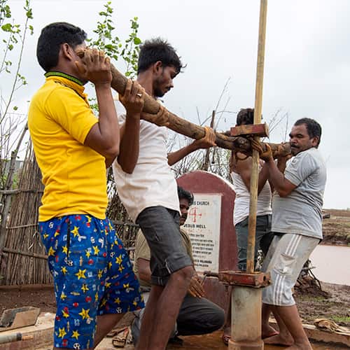 Local villagers repairing GFA World Jesus Well