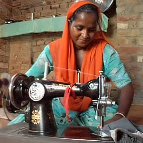 Woman in poverty received an income generating gift of a sewing machine through GFA World Christmas gift catalog