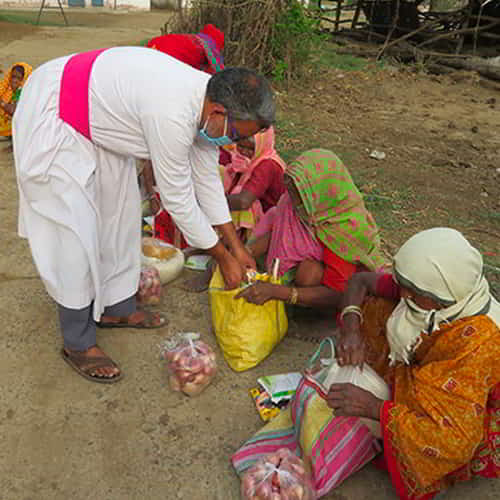 GFA World (Gospel for Asia) missionary distributing food to those in poverty