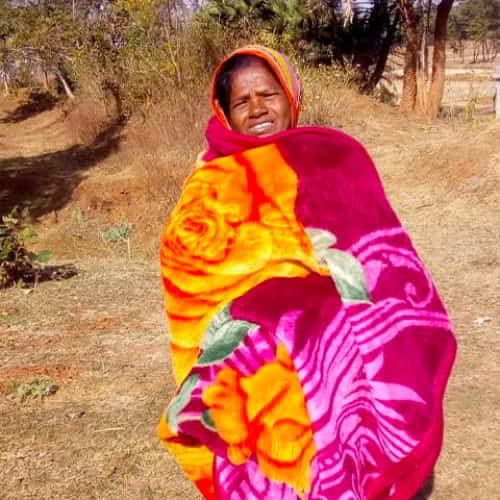 Sabela, a widow, received a warm blanket through GFA World (Gospel for Asia) gift distribution