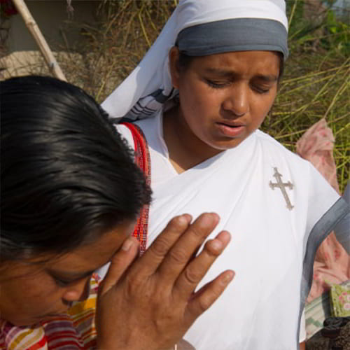 GFA World (Gospel for Asia) women missionaries praying for widows