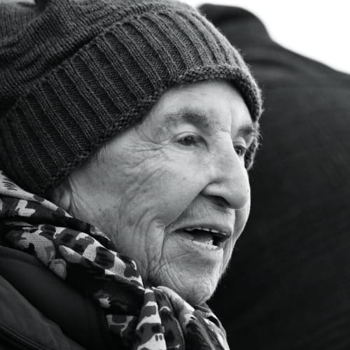 Elderly woman enduring the cold weather