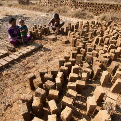 Man with his wife and child laboring in a brick kiln in South Asia