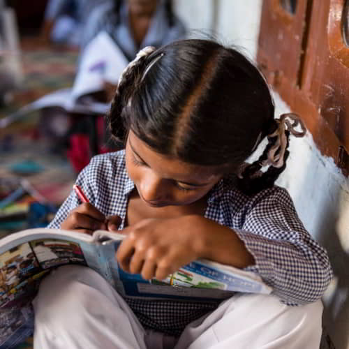 Young girl writing in GFA World child sponsorship program