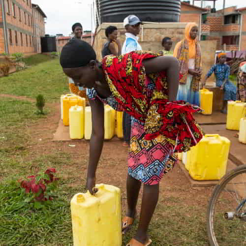 Woman from Rwanda, Africa, collects clean water through GFA World Jesus Wells