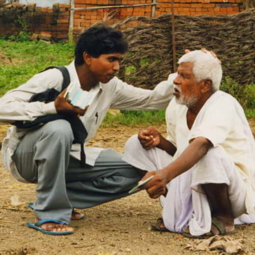 GFA World national missionary sharing the love of Jesus to an elderly man in South Asia
