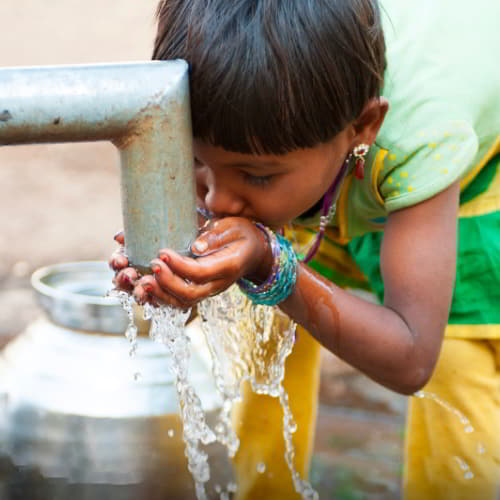 Young girl enjoying access to clean water through GFA World Jesus Wells