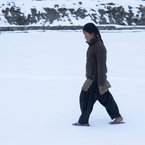 Girl in poverty walking in the snow